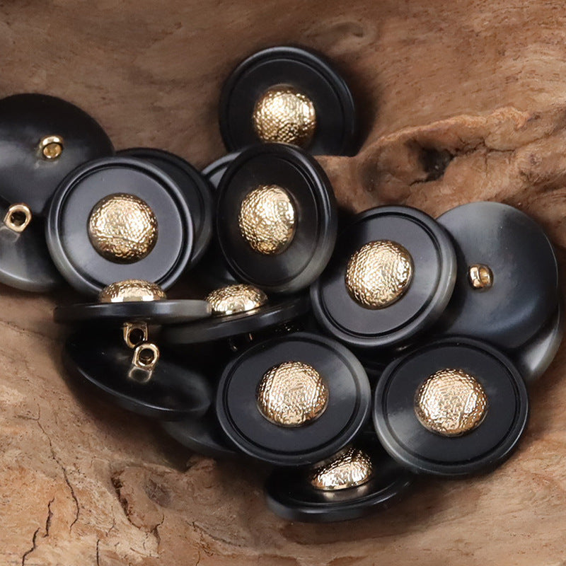 Black resin buttons with textured gold-tone caps and metal shanks, cap-shaped tops