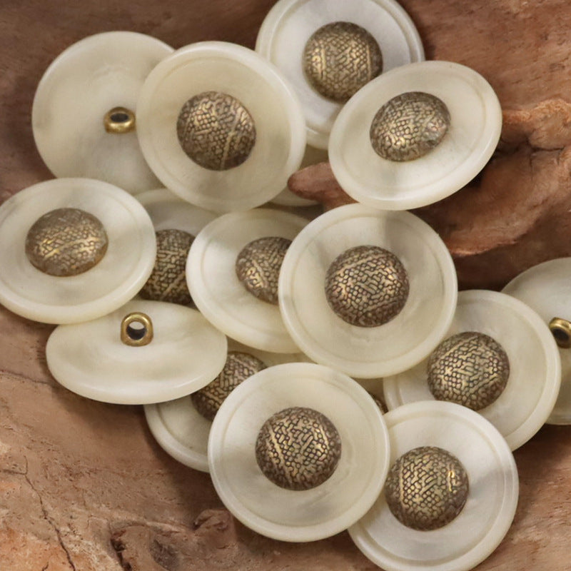 Cream resin buttons with bronze-gold textured caps and metal shanks