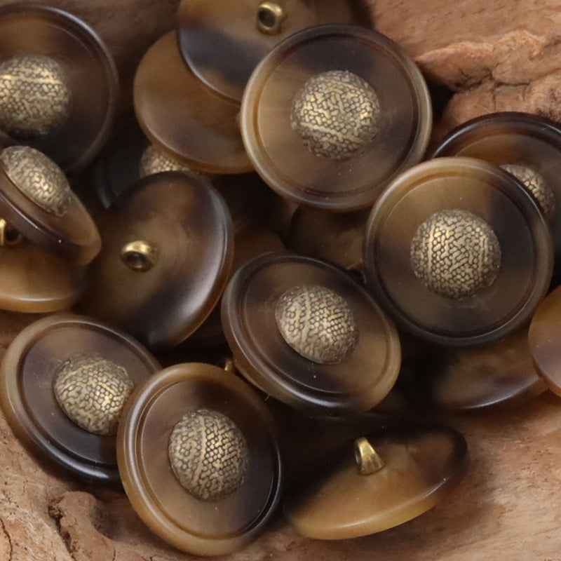 Assorted brown and dark resin buttons with gold-tone textured caps and metal shanks