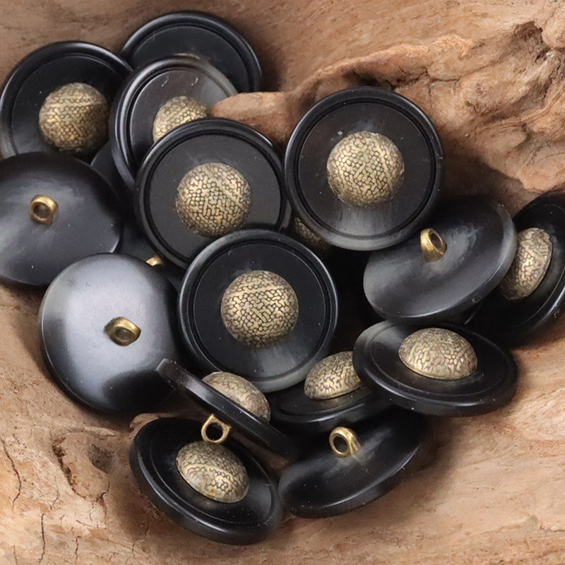 Black resin buttons with gold-tone textured caps and metal shanks, cap-shaped design