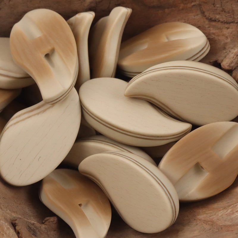 Beige comma-shaped matte resin shank buttons with slit shank hole
