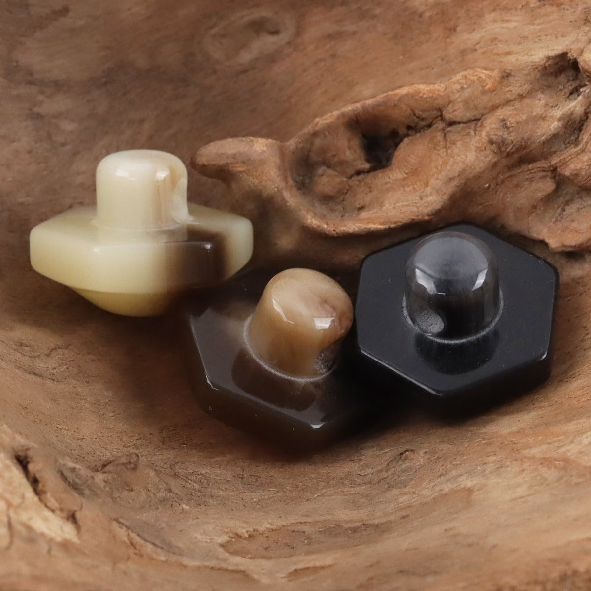 Beige and black 26mm hex resin shank buttons, glossy front and shank
