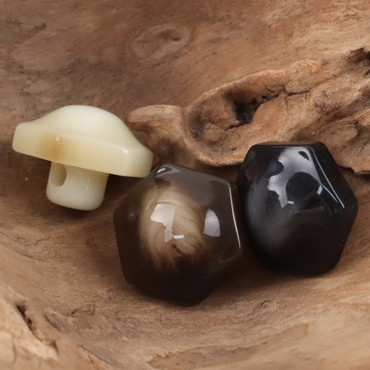 Beige, coffee, and black 26mm hex resin shank buttons with loop backs