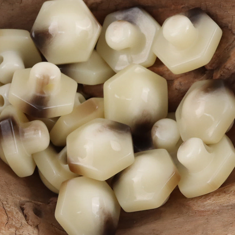 Beige 26mm hex resin shank buttons, glossy faceted surface and loop