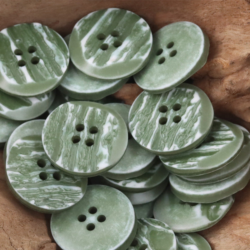 Green resin buttons with woodgrain, round 4-hole layout, beveled edges