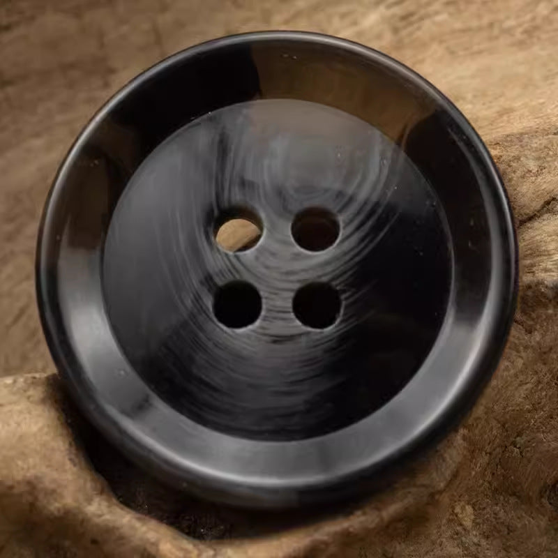 Black resin 4-hole button, round with brush-stroke marbling pattern