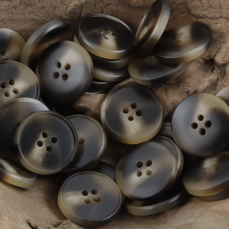 Assorted round resin coat buttons in dark gray/black, multiple 4-hole designs