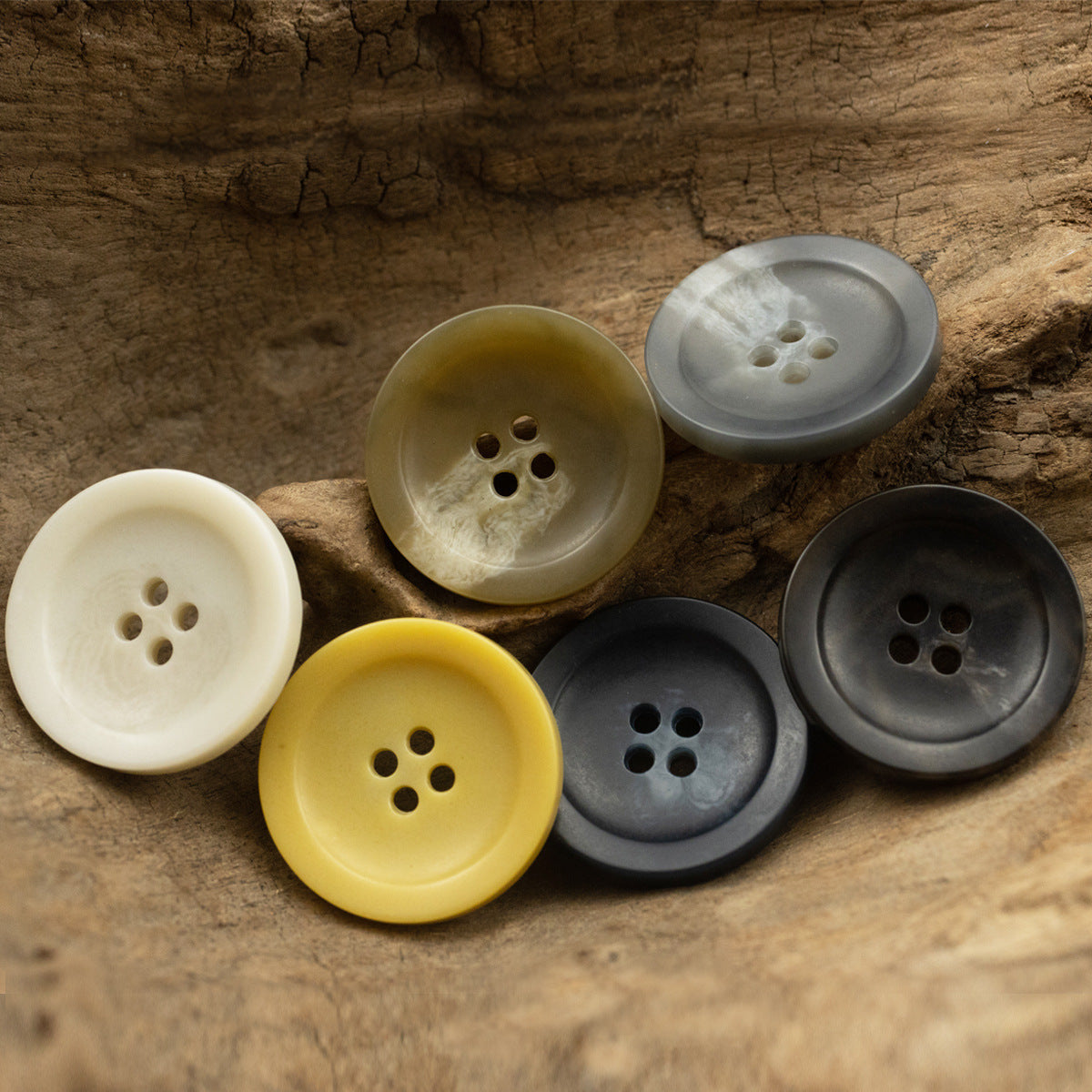 Assorted 4-hole coat buttons: cream, olive, yellow, slate gray, dark gray, black