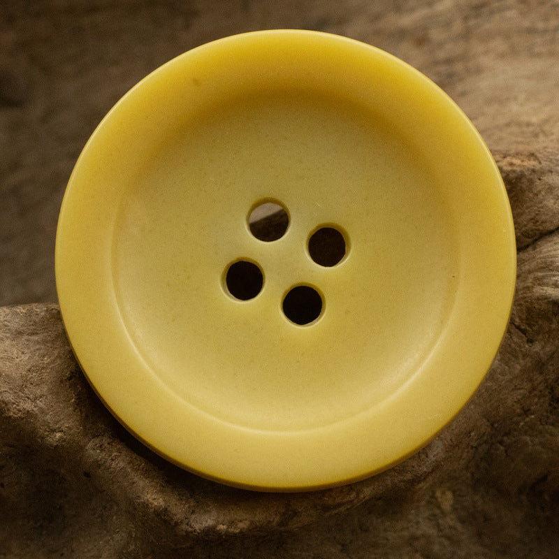 Wide-edged 4-hole urethane button, yellow, round bowl shape