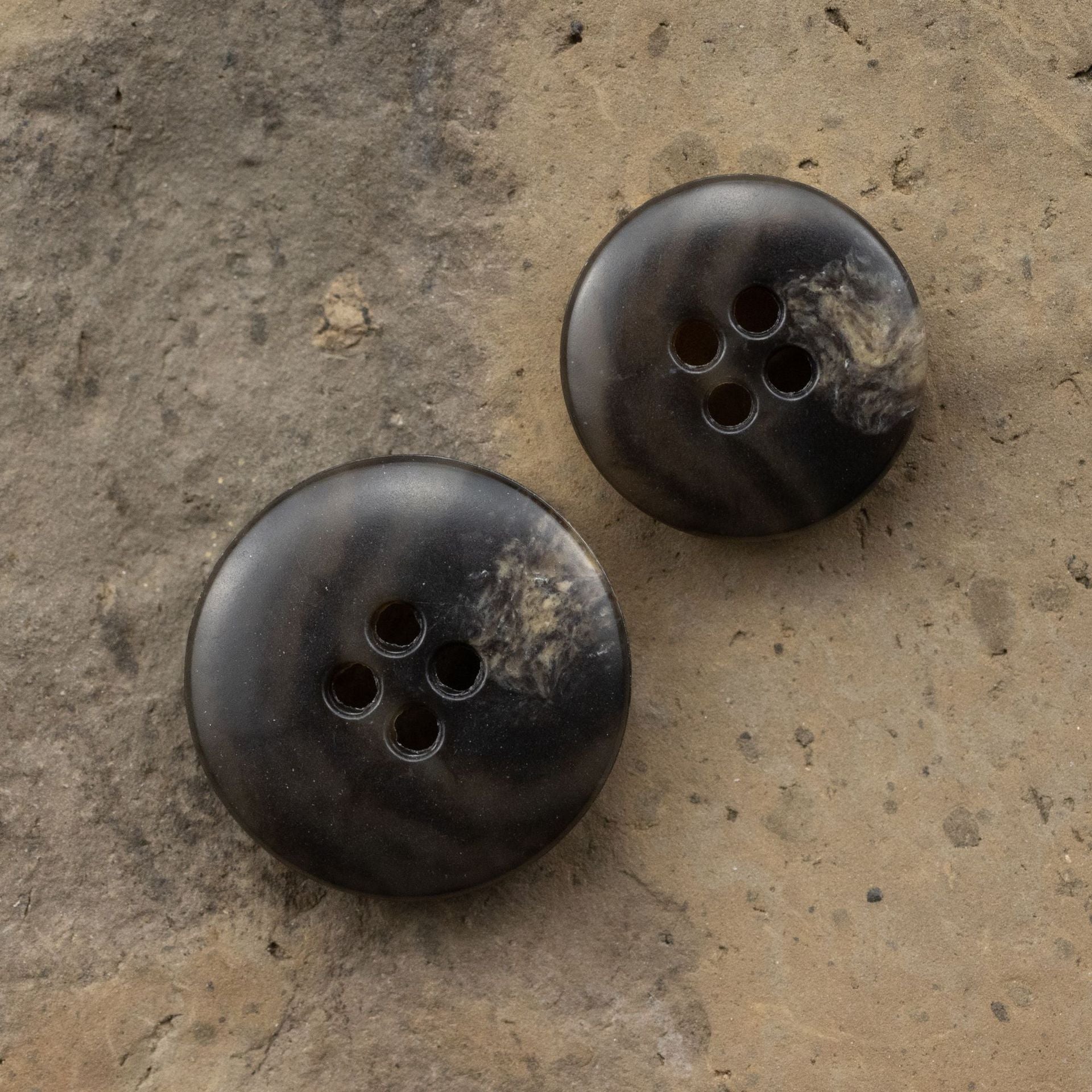 Pair of dark brown urea buttons with spotted leopard-style pattern and 4 holes