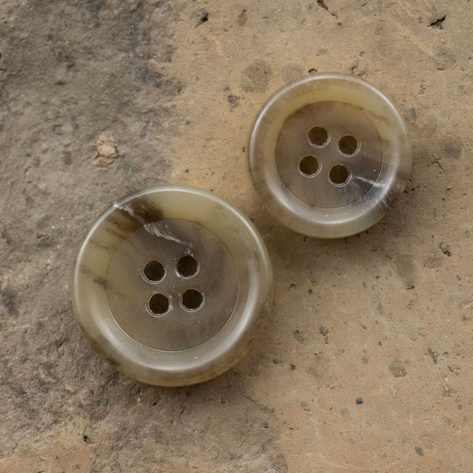 Pair of coffee round urea buttons, 4-hole design with subtle marbled look