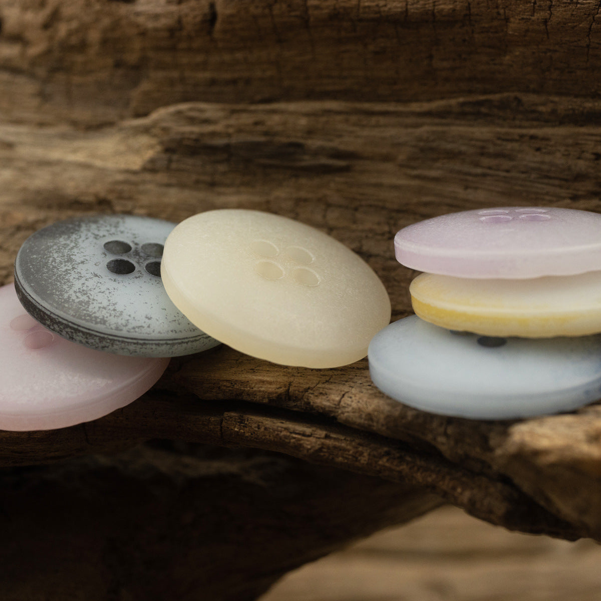 Grey, cream, light yellow and pink imitation bark buttons with four holes