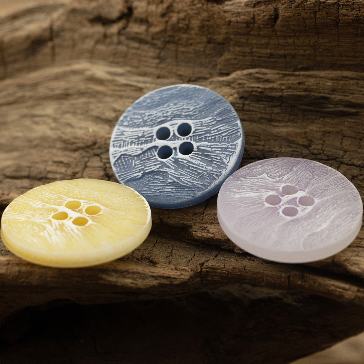Blue-grey, yellow and light pink imitation bark buttons with four holes
