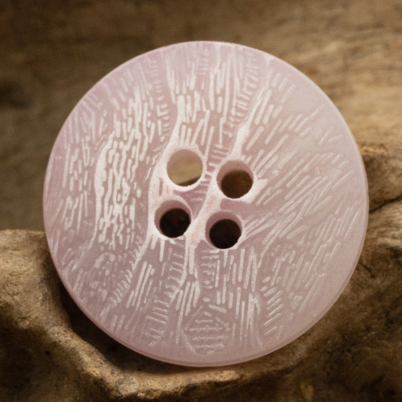 Light pink imitation bark button with four holes and distressed texture