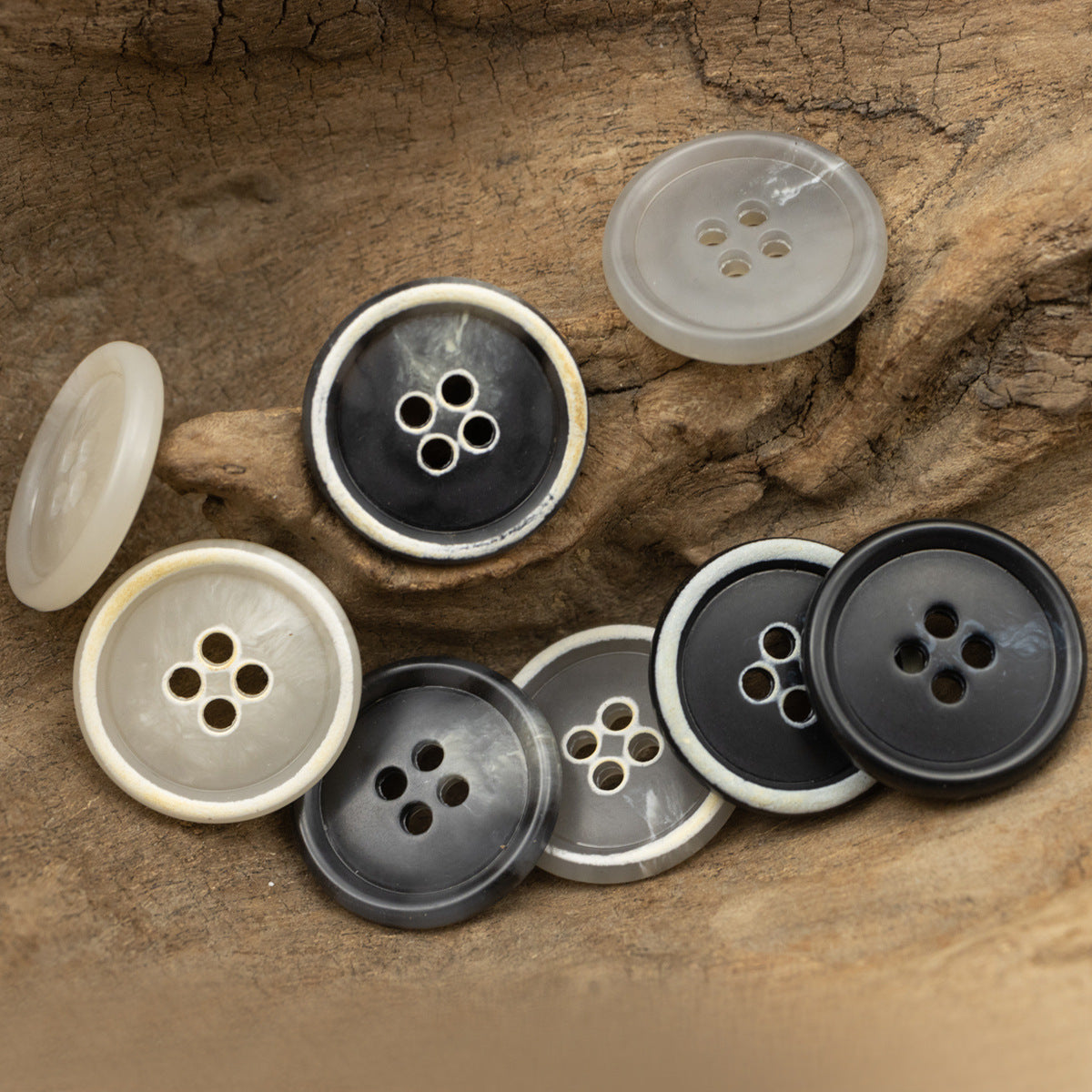 Assorted round 4-hole imitation horn buttons in light to dark tones