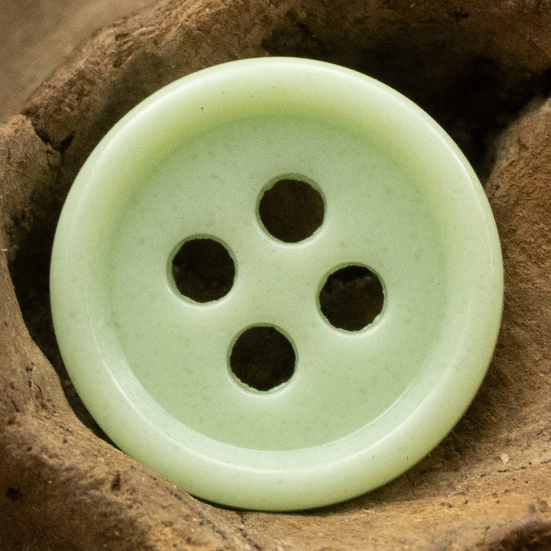 Light green 4-hole round urea resin button