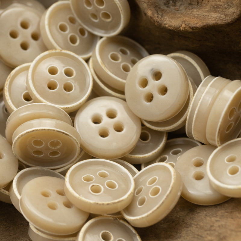 Cream 4-hole round buttons, many pieces in a layered cluster