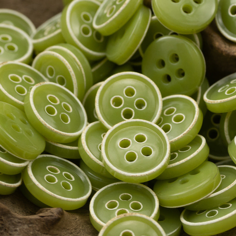 Green 4-hole round buttons with white rim detail, assorted sizes