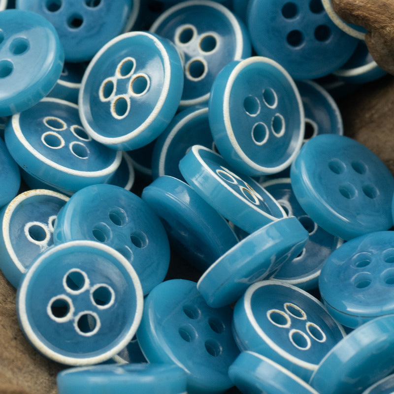 Blue-toned 4-hole round buttons with white rim detail, assorted pack