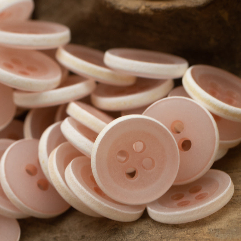 Matte frosted round urea buttons, light pink/peach, four-hole design