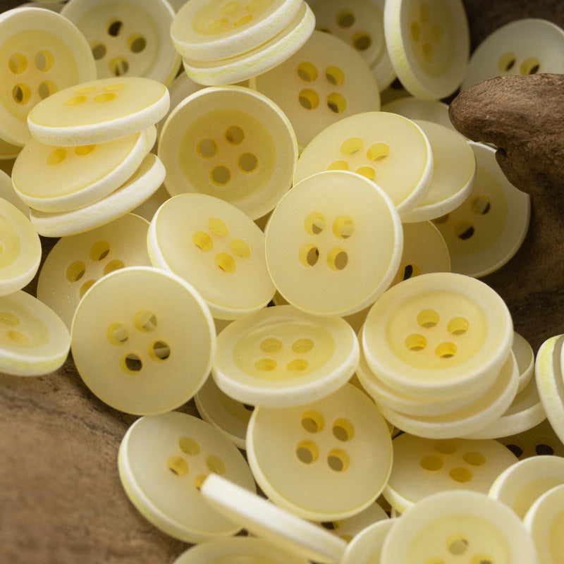 Matte frosted round urea buttons, light yellow, four-hole design