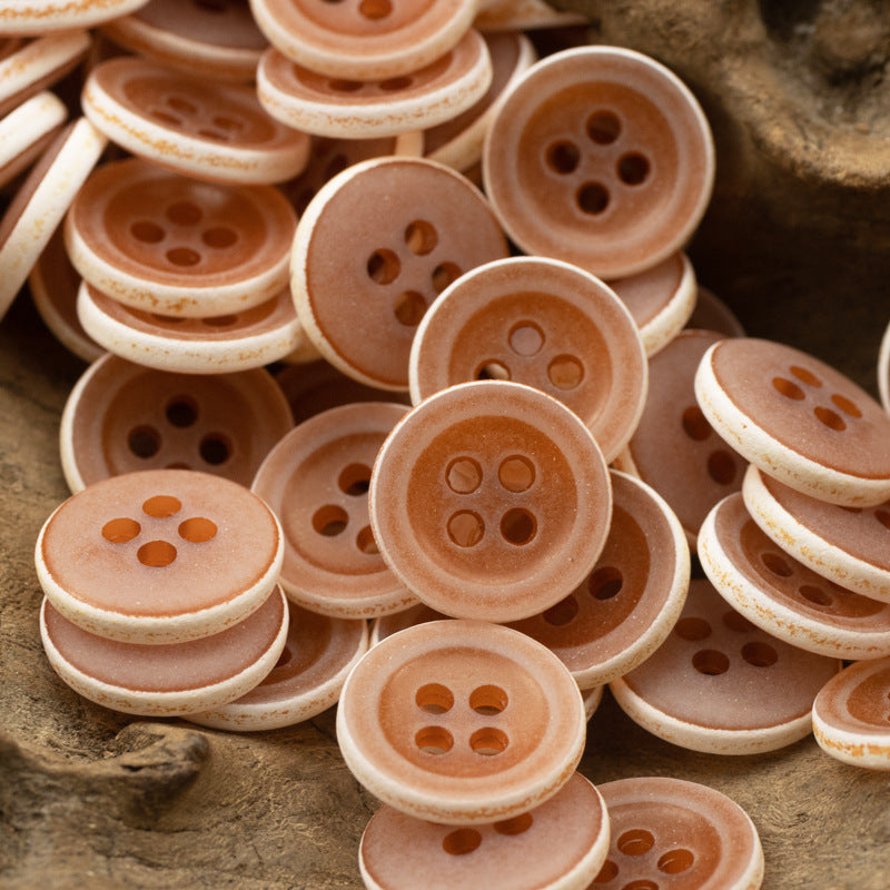 Matte frosted round urea buttons, orange/brown tones, four-hole design