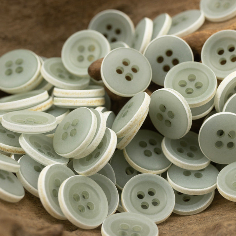Matte frosted round urea buttons, mixed light green and white tones, four-hole