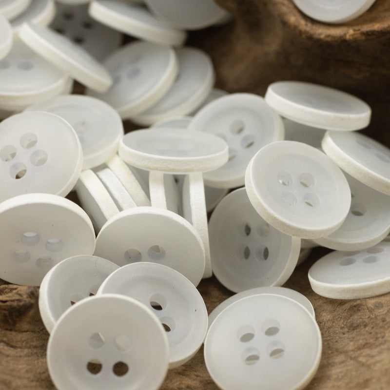 Matte frosted round urea buttons, white/cream, four-hole design