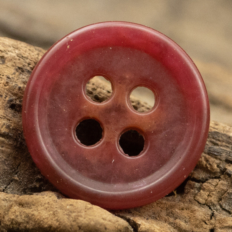 Burgundy round urea shirt button (4-hole) close-up