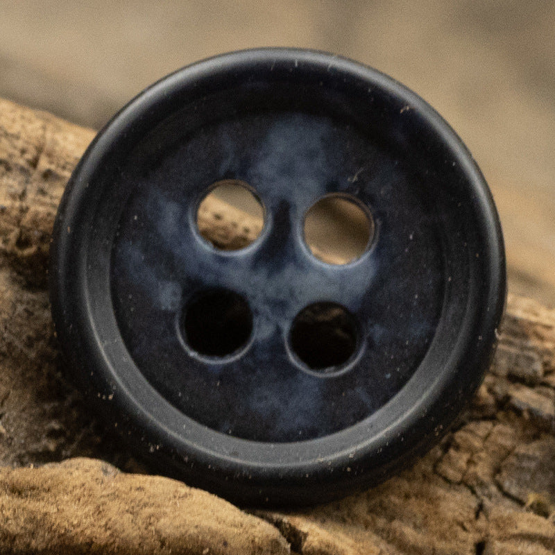 Dark navy round urea shirt button (4-hole) close-up