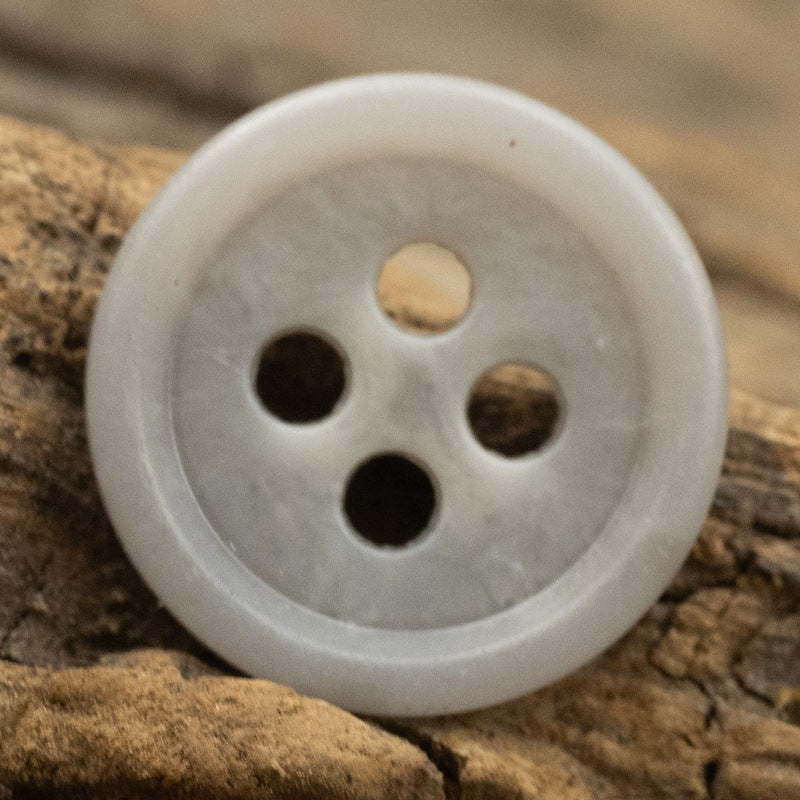 White round urea shirt button (4-hole) close-up