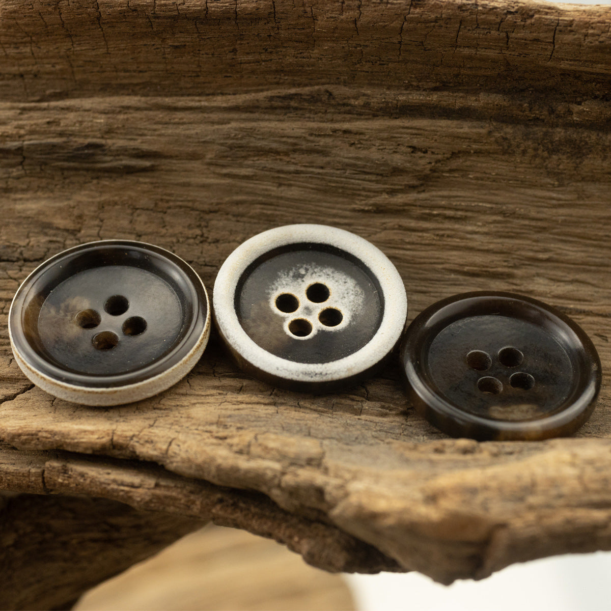 Dark-brown urea coat buttons with burnt edge, 4-hole fronts, mixed rim finish