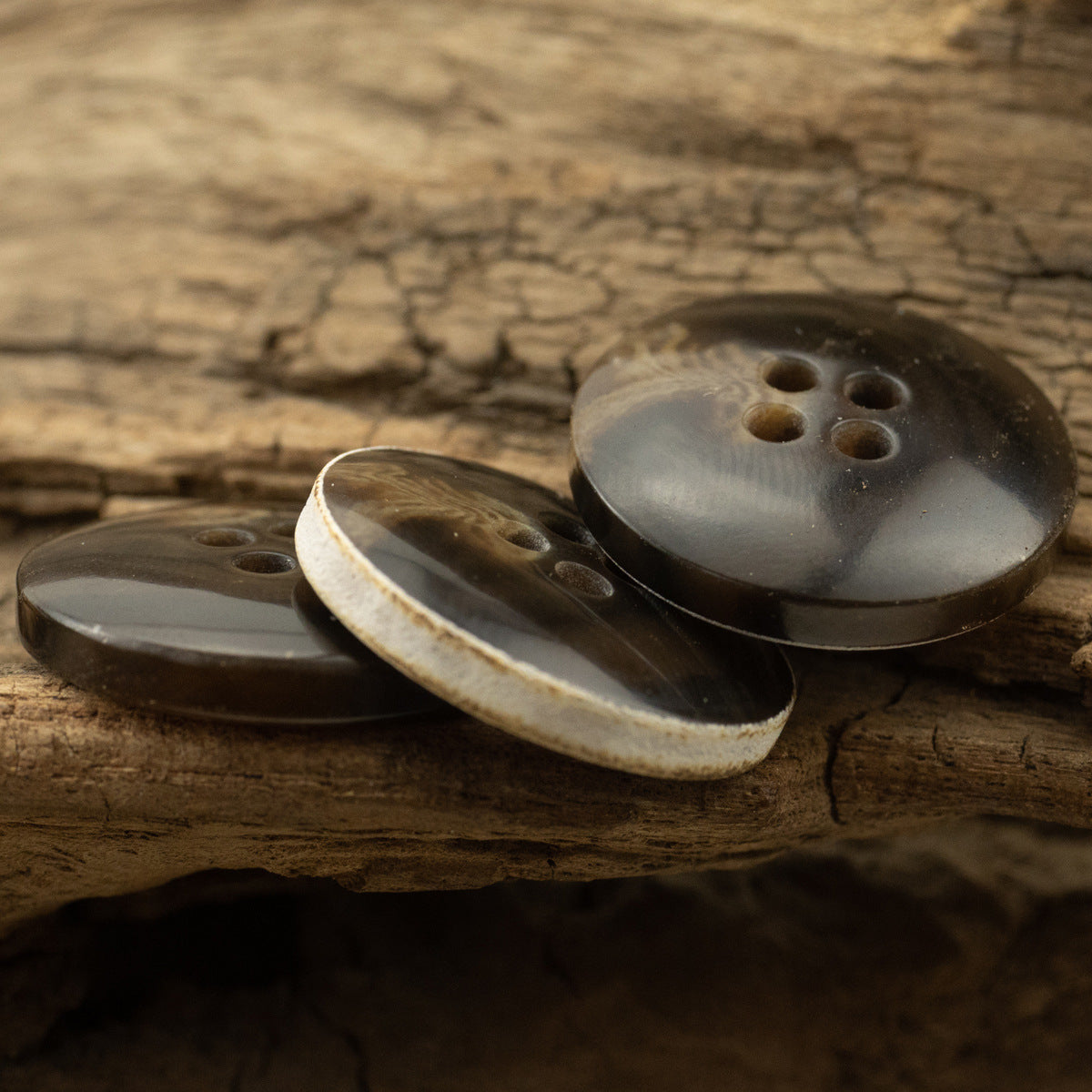 Dark-brown urea coat buttons showing front and back edges, 4 holes, 30-pack