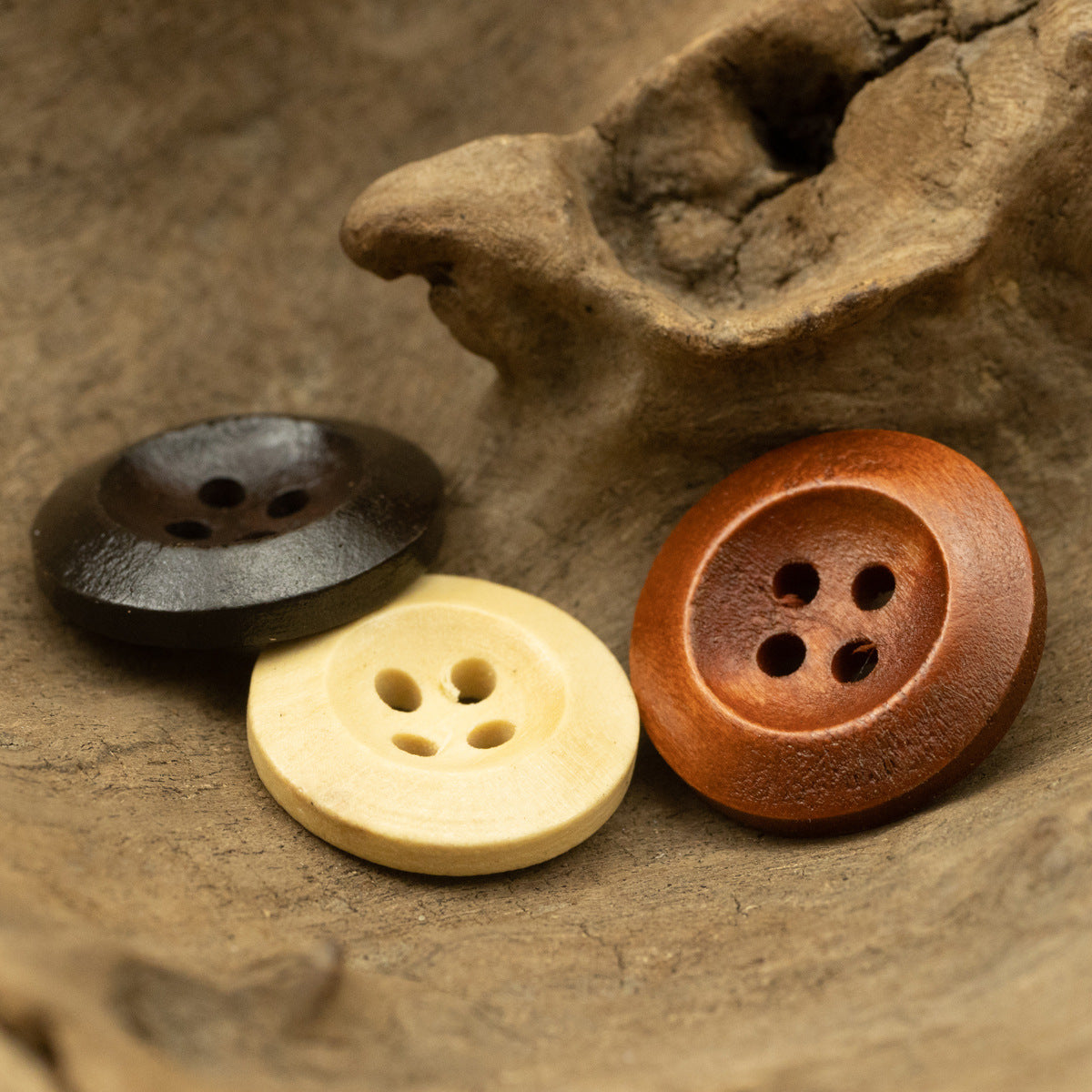 Pear wood buttons in cream and rust-brown, round with four holes
