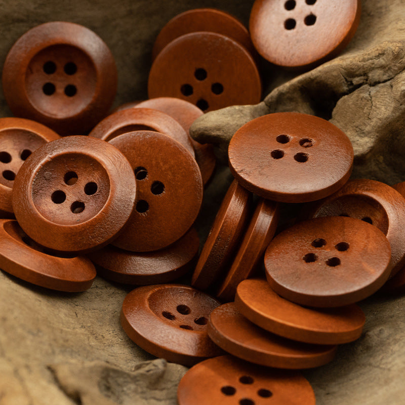 Assorted dark brown wooden buttons, round with four holes