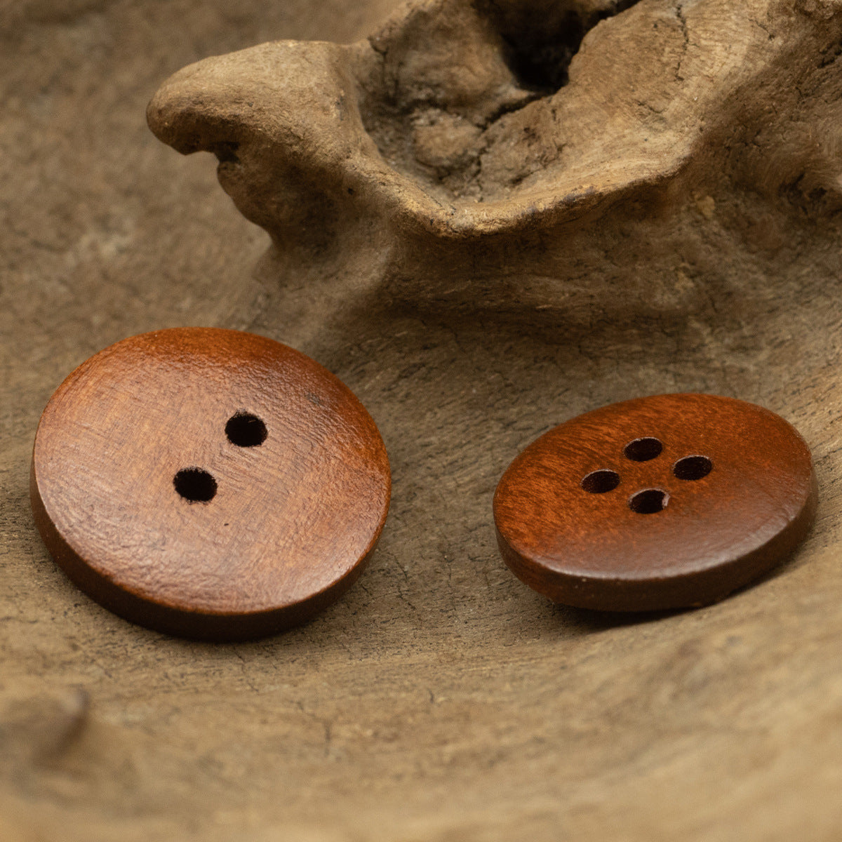 Cat’s Eye red-brown wooden buttons: one with 2 holes, one with 4 holes