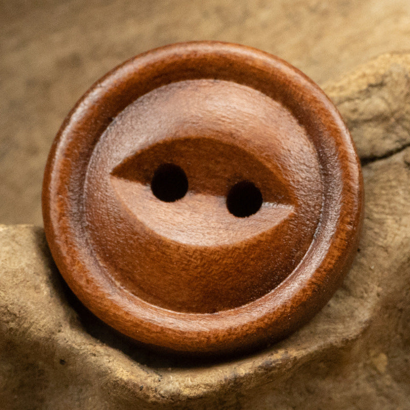 Red-brown wooden button with 2 holes and cat’s-eye style for cotton and linen