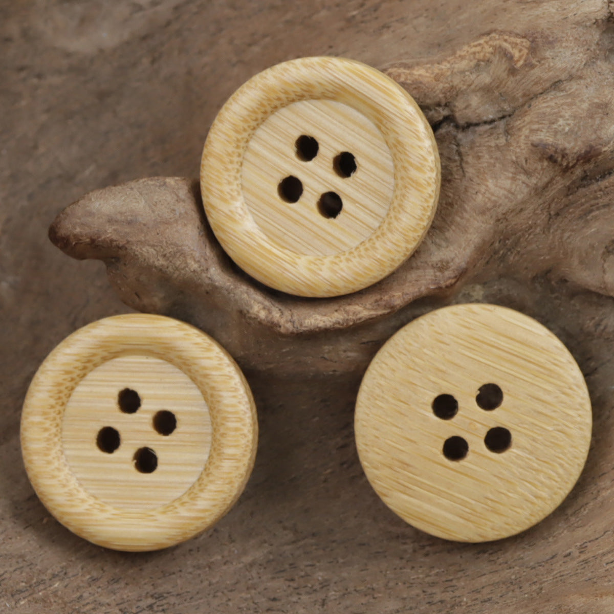 Three round bamboo buttons, thick rounded edge, four holes, light tan