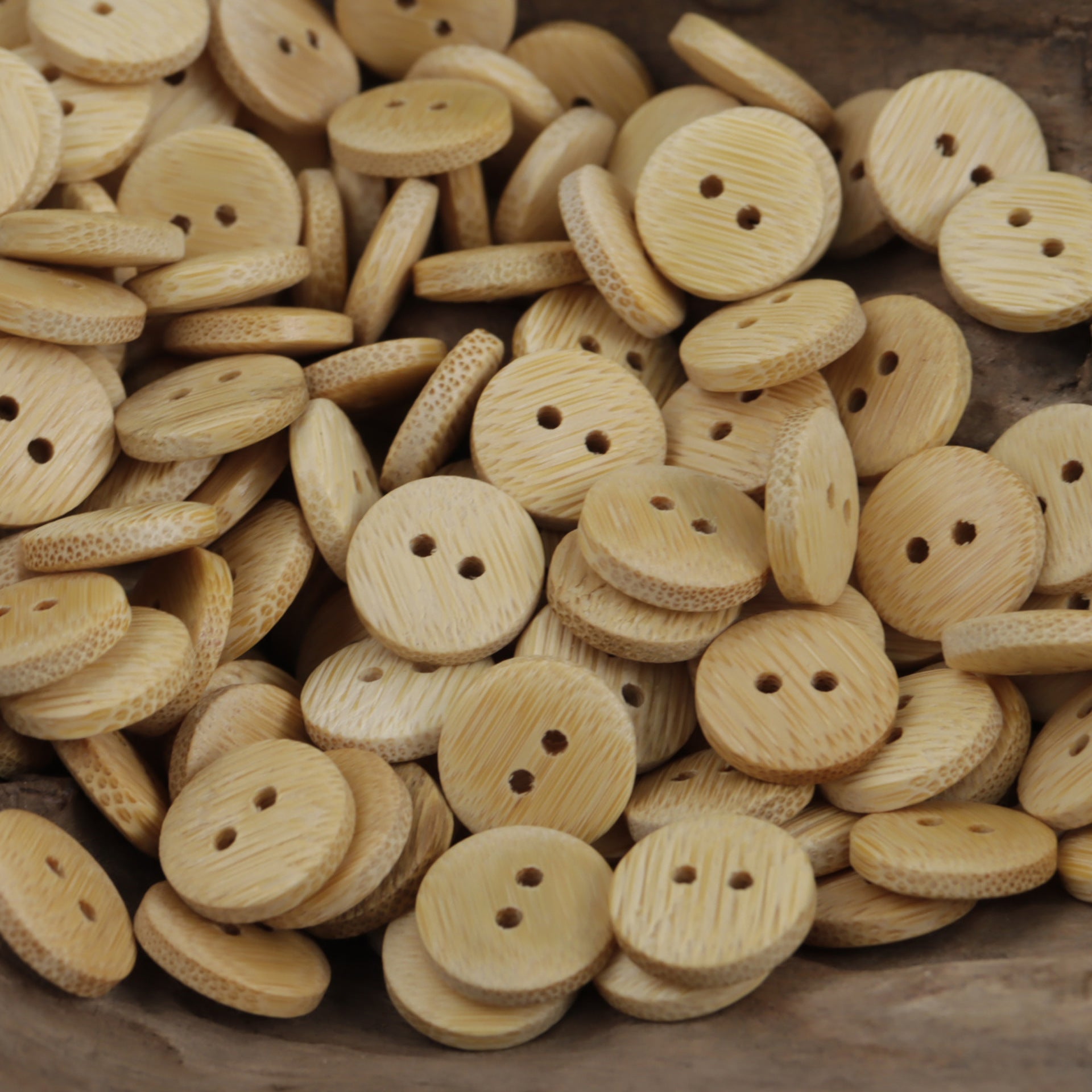 Mixed pack of natural bamboo buttons with two holes, light tan woodgrain