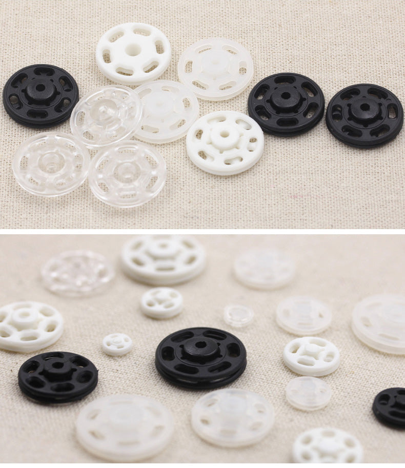 Mixed set of invisible snap buttons: black, white, and clear plastic discs