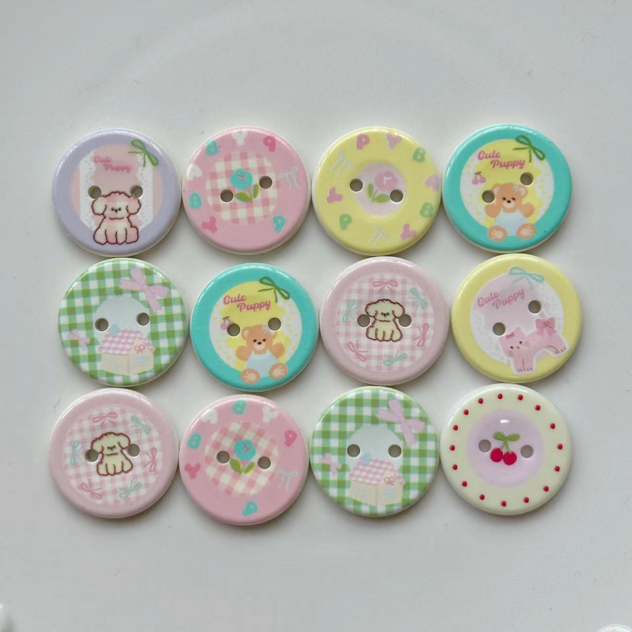 Group of 25mm 2-hole resin buttons, cats and dogs with check and pastel patterns