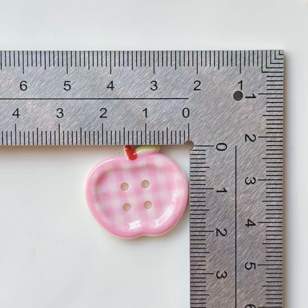 Pink plaid apple 4-hole resin button, glossy finish, red-and-green loop accent
