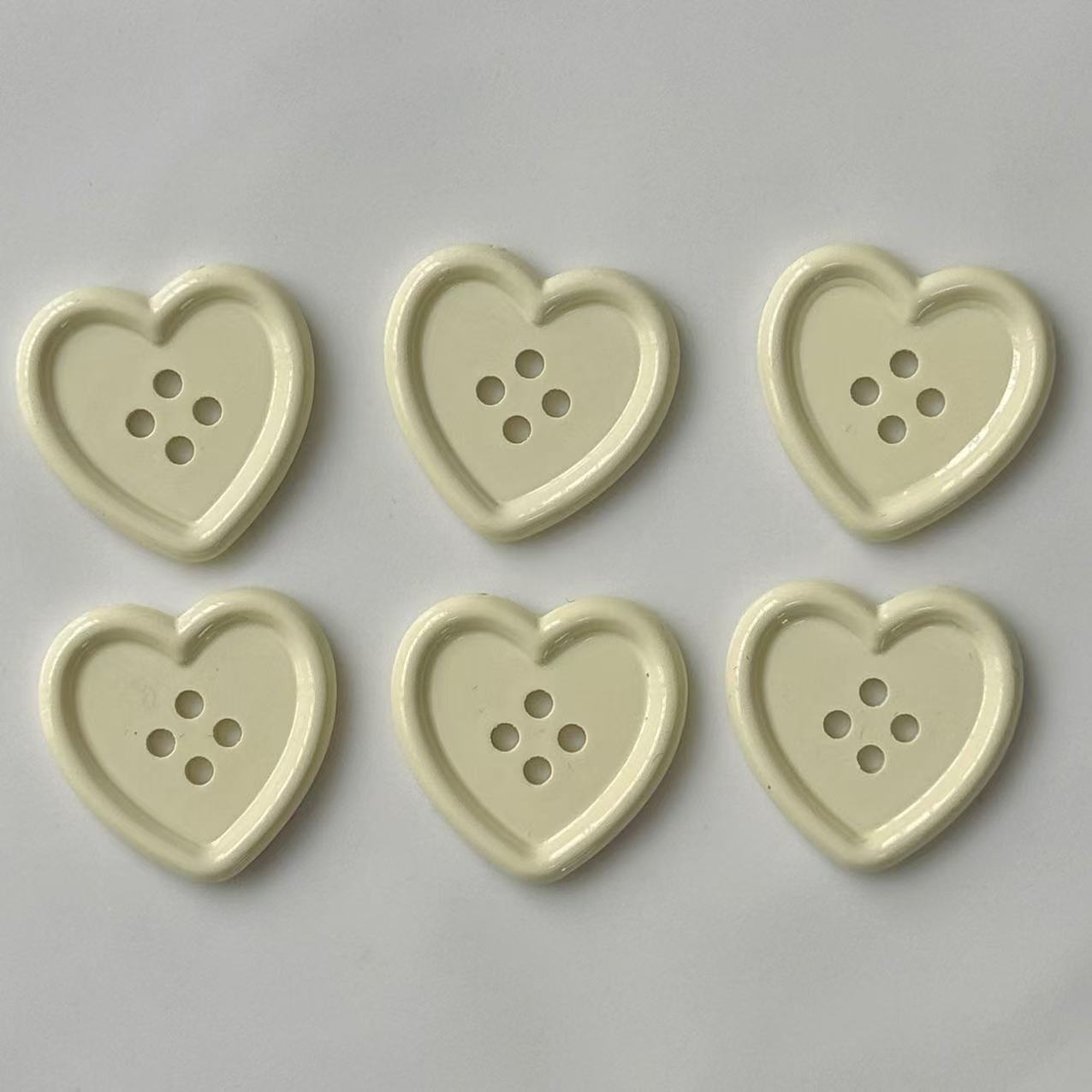 Shiny beige heart plastic craft buttons, heart design with 4 holes (6 shown)