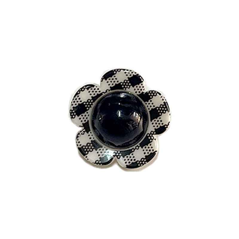 Black flower shank button with glossy black pearl center and check-pattern petals.
