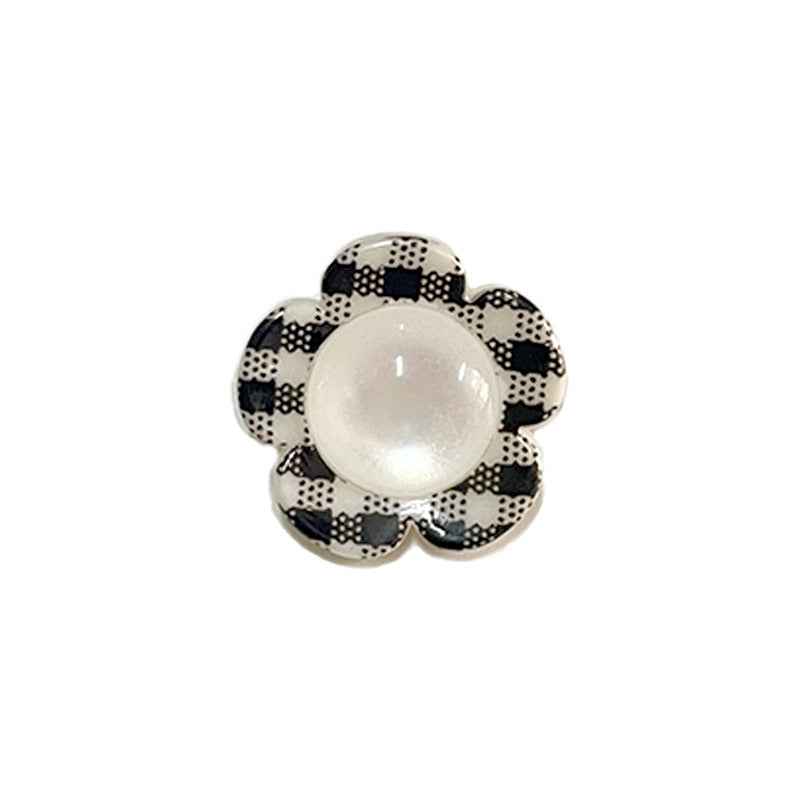 Black-and-white check flower shank button with white pearl center.