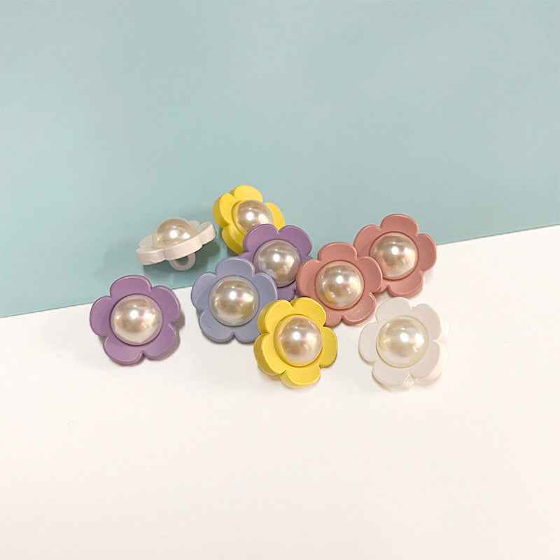 Colorful flower shank buttons with pearl centers: yellow, purple, pink, blue, cream, white.