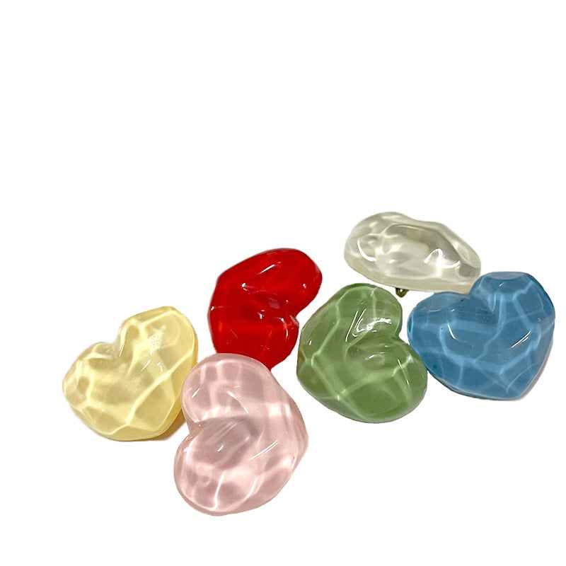 Heart-shaped resin shank button, translucent red, concave-convex surface