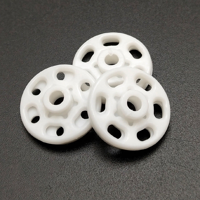 White round nylon snap buttons, front discs with central snaps and attachment holes
