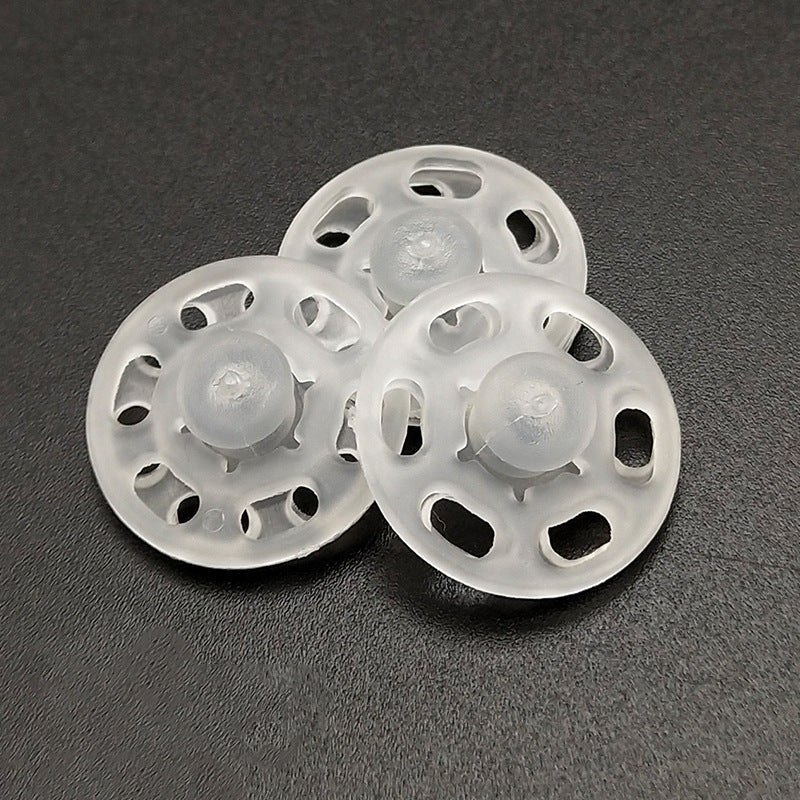 Transparent round nylon snap buttons, front discs with central snap posts and holes