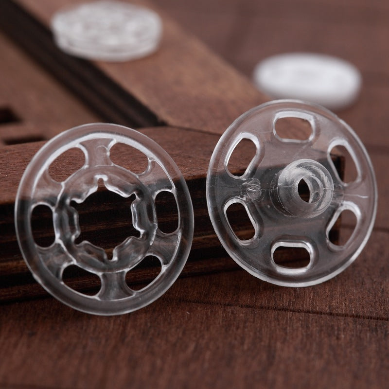 Clear round nylon snap buttons, front discs with ring centerpiece and side holes
